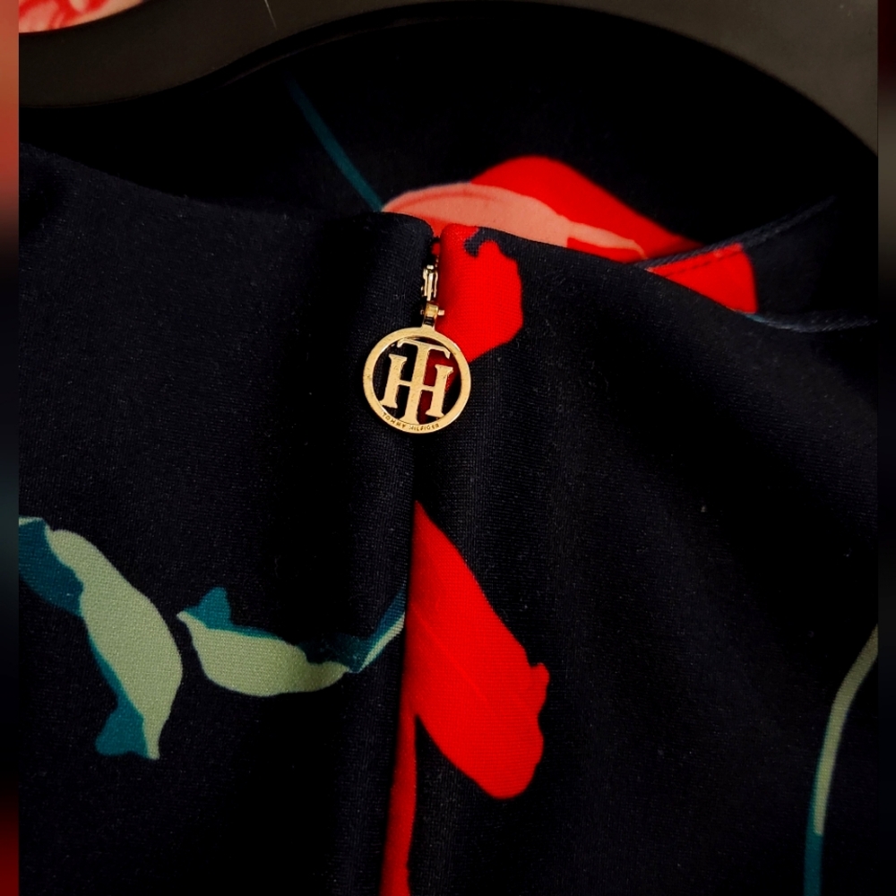 A Tommy Hilfiger dress with vibrant colors and flower designs on it; size 8